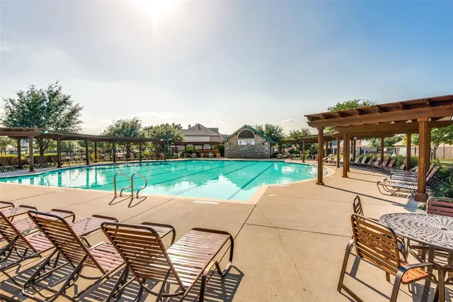 an outdoor sitting area with furniture and garden