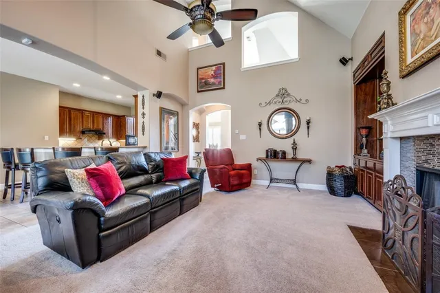 a living room with furniture kitchen view and a fireplace