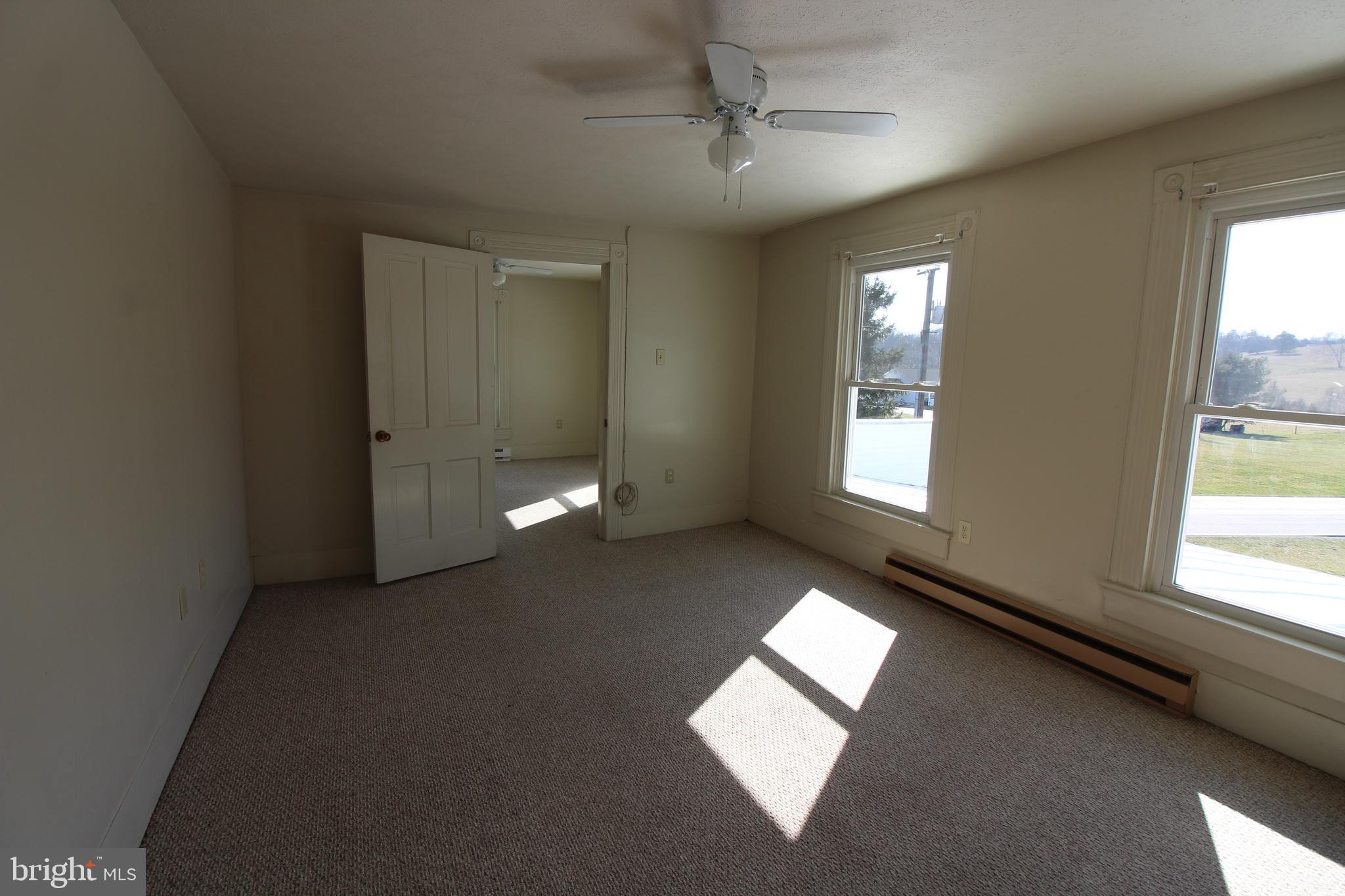 18947 Senedo Road, Unit 4 Edinburg, VA 22824 - Photo 12 of 15 a view of an empty room with a window