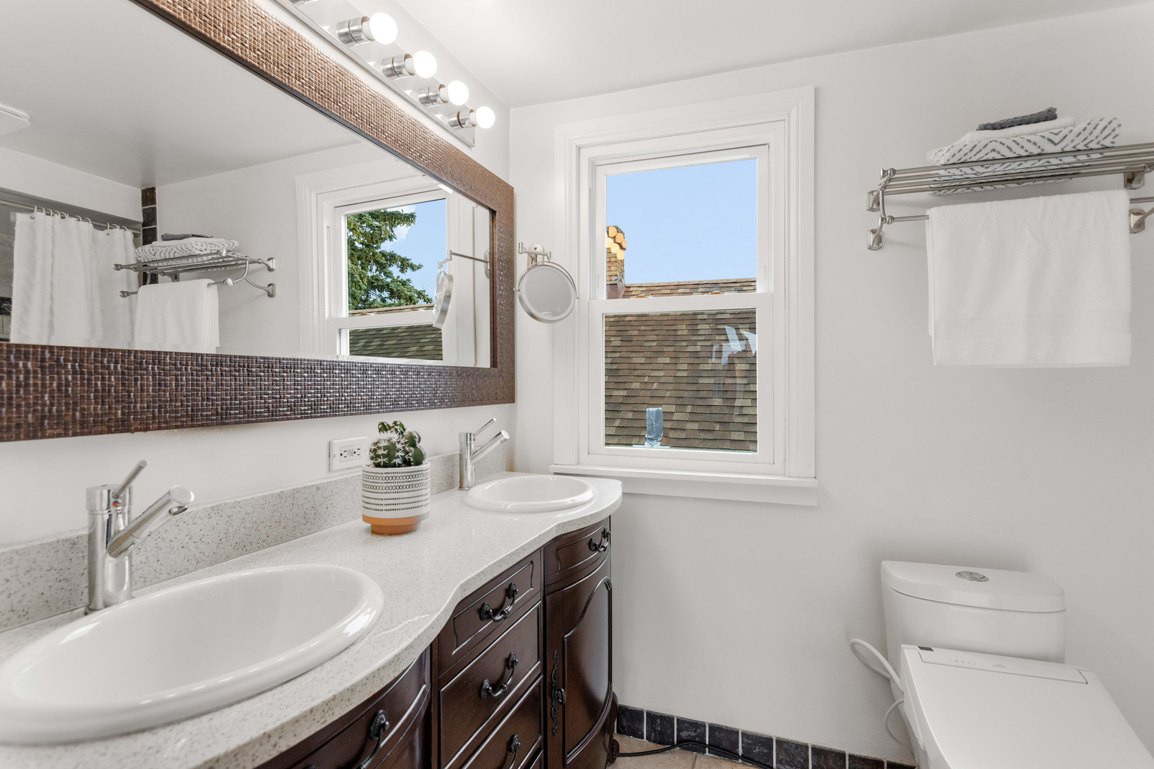 3201 Park Avenue Brookfield, IL 60513 - Photo 14 of 22 a bathroom with a granite countertop sink a toilet a mirror and a window