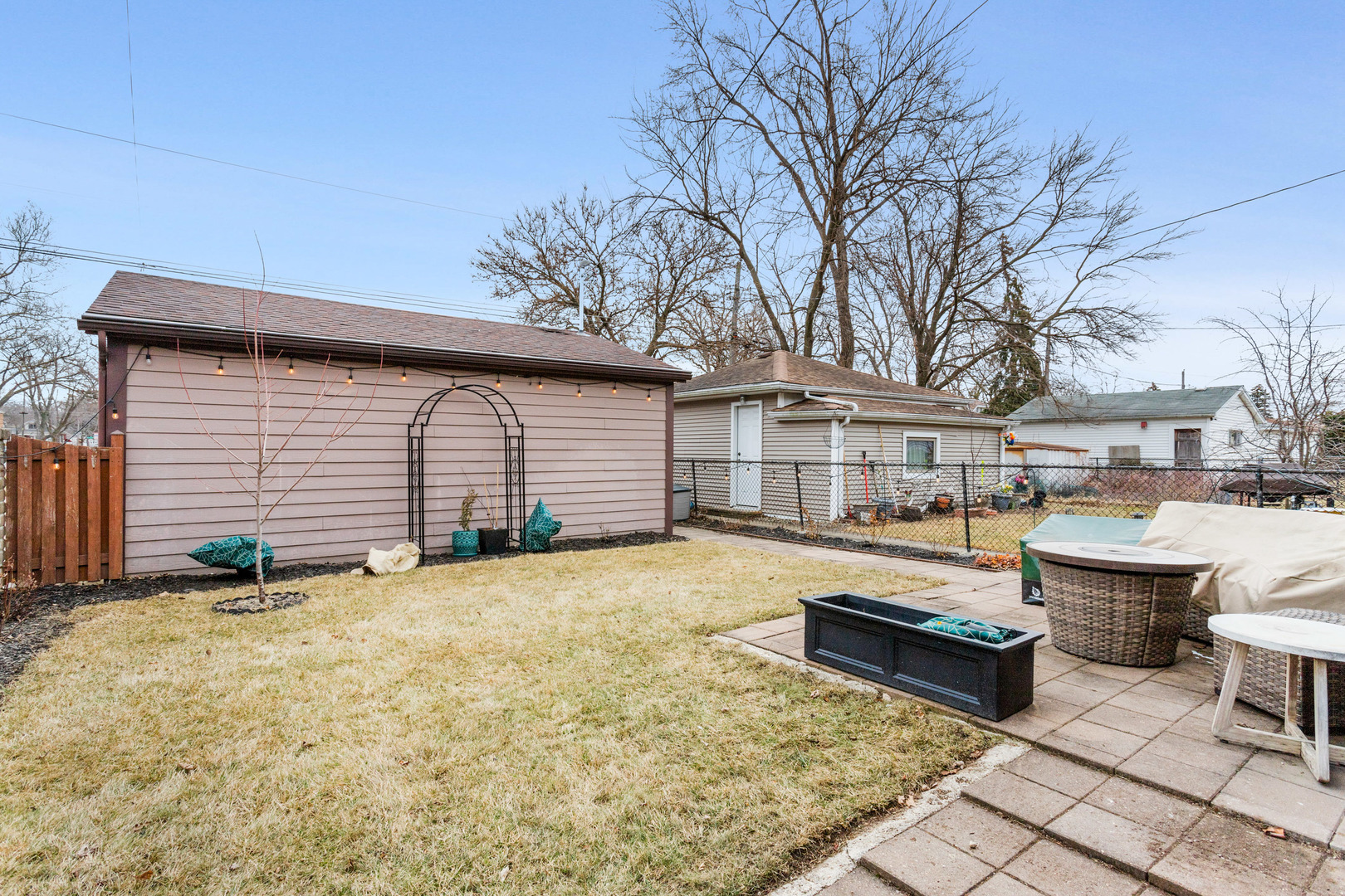 3201 Park Avenue Brookfield, IL 60513 - Photo 18 of 22 a view of a house with patio chairs and a fire pit