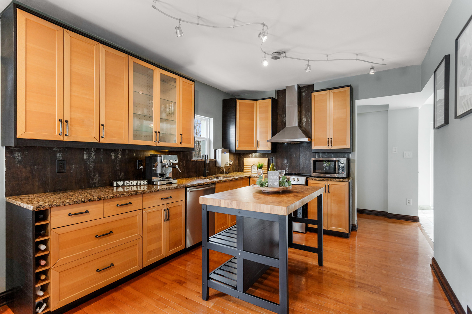 3201 Park Avenue Brookfield, IL 60513 - Photo 6 of 22 a kitchen with stainless steel appliances granite countertop wooden cabinets a stove top oven a sink and dishwasher with wooden floor