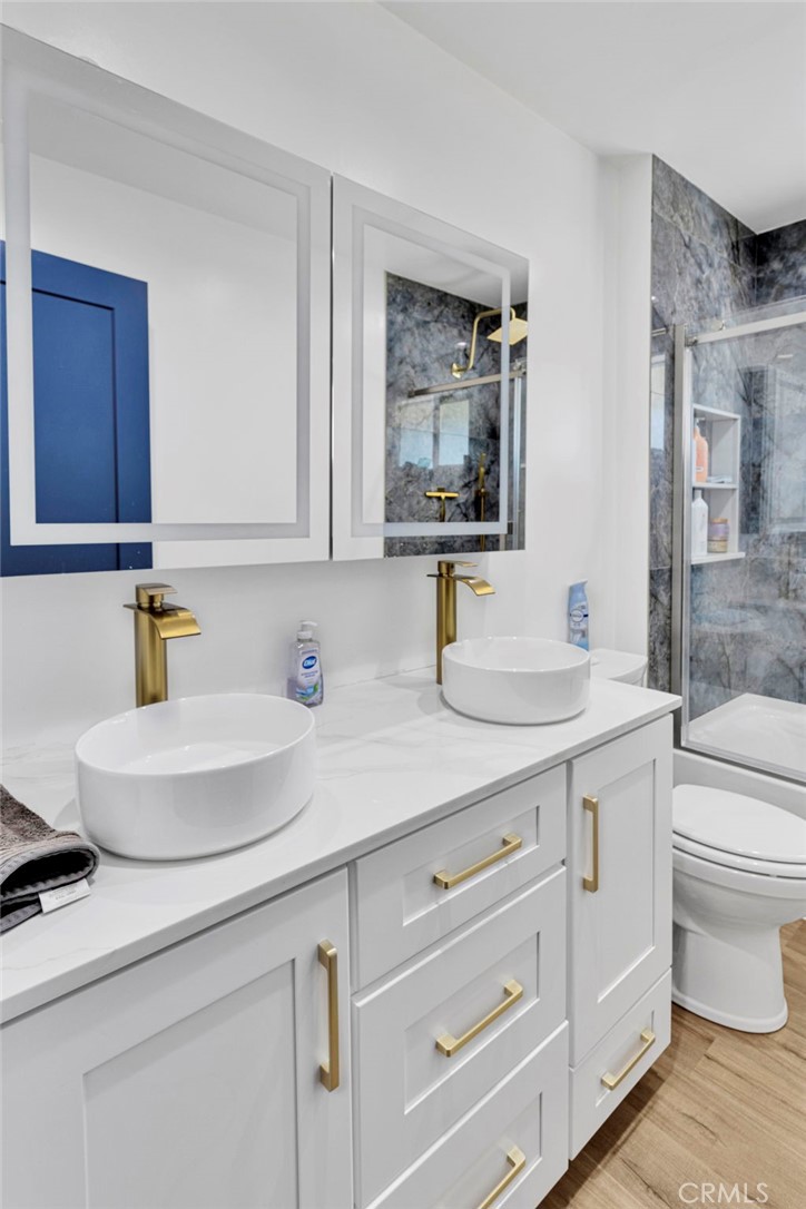 8038 Begonia Road Phelan, CA 92371 - Photo 24 of 49 a bathroom with a toilet a sink and mirror