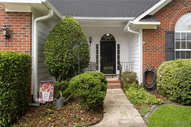 a view of a living room with furniture and a wooden floor