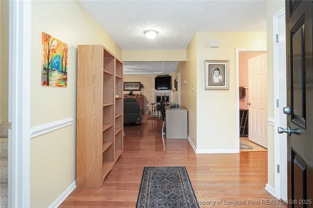 a view of a hallway with wooden shelves