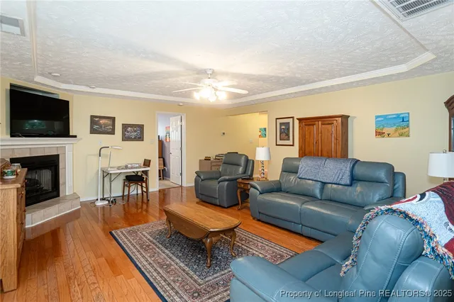 a kitchen with stainless steel appliances granite countertop a stove a sink dishwasher and a refrigerator with white cabinets