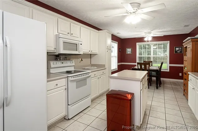a kitchen with stainless steel appliances a refrigerator sink and cabinets
