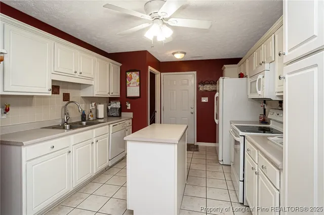 a kitchen with cabinets appliances and a counter top space