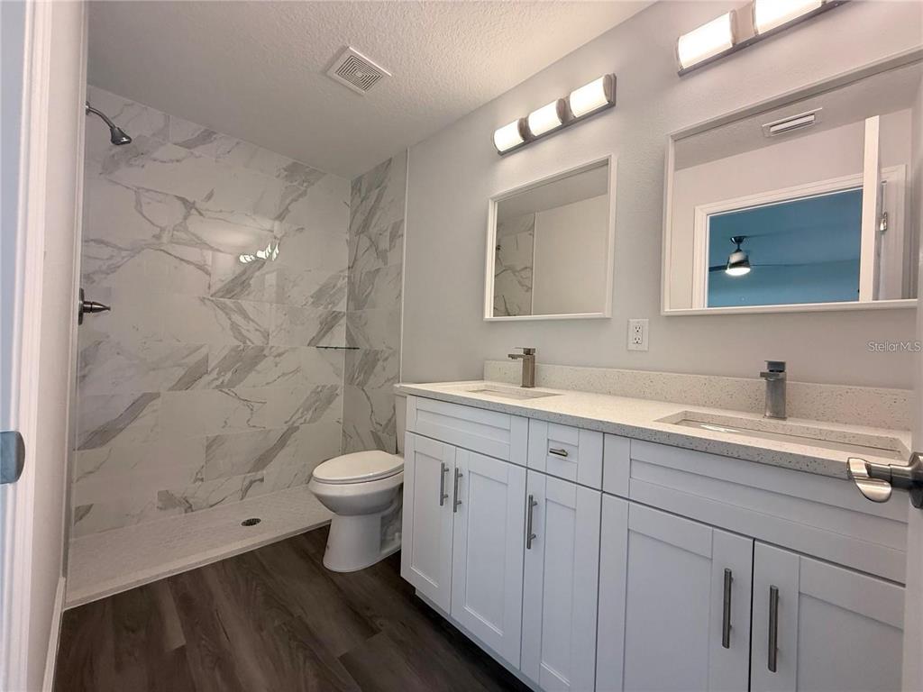3577 Southwest 149th Terrace Ocala, FL 34481 - Photo 17 of 31 a bathroom with a double vanity sink toilet and a mirror