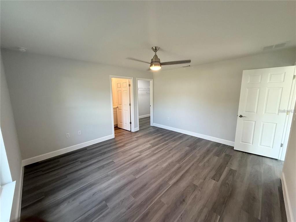 3577 Southwest 149th Terrace Ocala, FL 34481 - Photo 19 of 31 an empty room with wooden floor ceiling fan and window