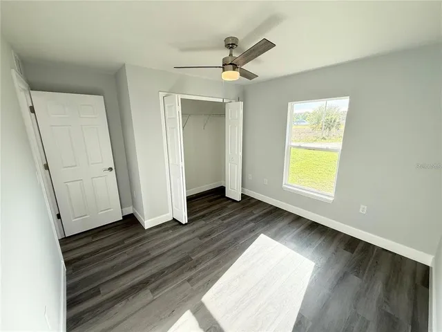 a view of empty room with wooden floor and cabinet