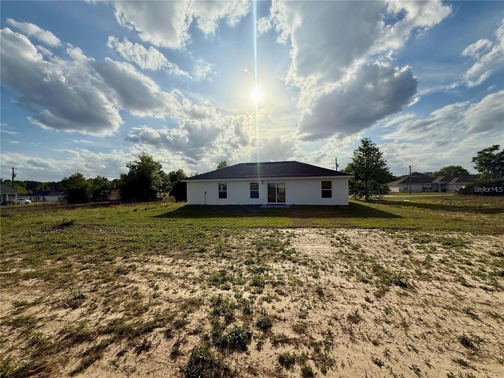 3577 Southwest 149th Terrace Ocala, FL 34481 - Photo 30 of 31 a view of a house with a yard