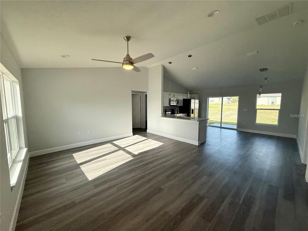 3577 Southwest 149th Terrace Ocala, FL 34481 - Photo 7 of 31 an empty room with wooden floor and windows