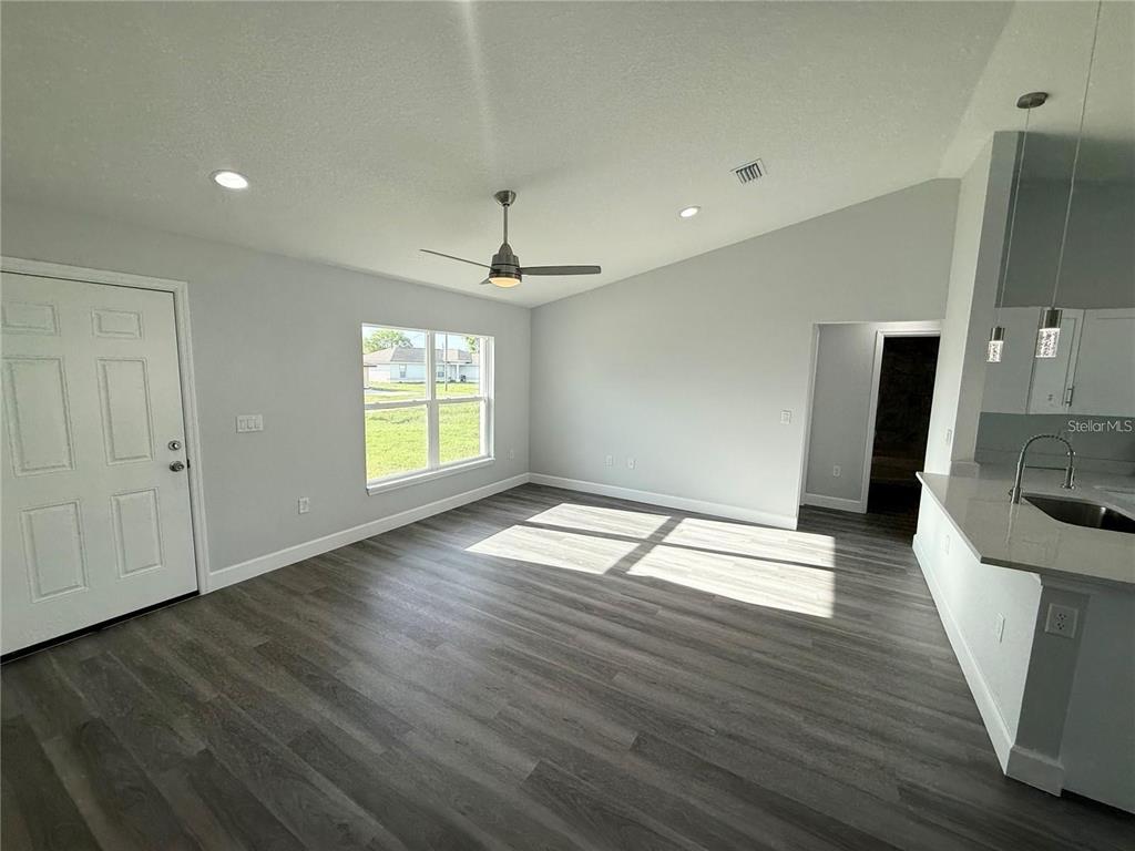 3577 Southwest 149th Terrace Ocala, FL 34481 - Photo 8 of 31 a view of empty room with wooden floor and fan