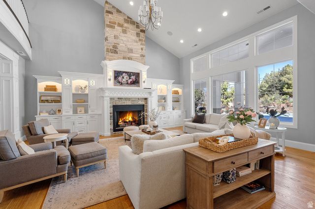 2917 Old Farm Road Washington, UT 84780 - Photo 15 of 105 Living area featuring vaulted ceiling, a fireplace, light wood-style flooring, and suspended lighting
