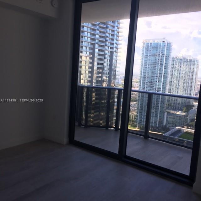 45 Southwest 9th Street, Unit 3201 Miami, FL 33130 - Photo 15 of 19 a view of an empty room with wooden floor and a window