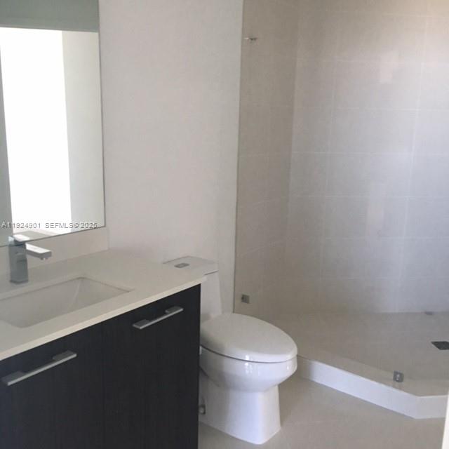 45 Southwest 9th Street, Unit 3201 Miami, FL 33130 - Photo 18 of 19 a bathroom with a sink a toilet a vanity and mirror