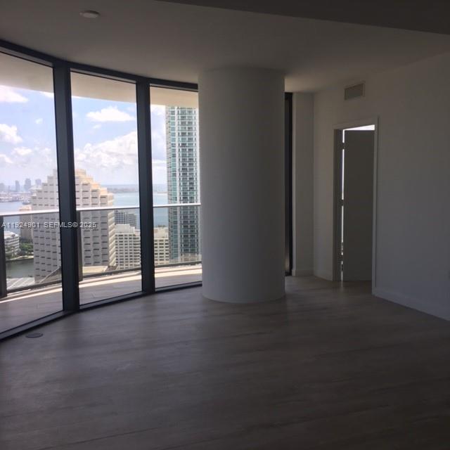 45 Southwest 9th Street, Unit 3201 Miami, FL 33130 - Photo 6 of 19 a view of an empty room with windows and city view