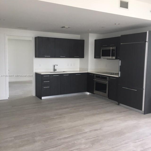 45 Southwest 9th Street, Unit 3201 Miami, FL 33130 - Photo 7 of 19 a view of an empty room with kitchen and sink