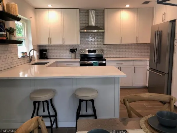 a kitchen with stainless steel appliances a stove a sink and a refrigerator