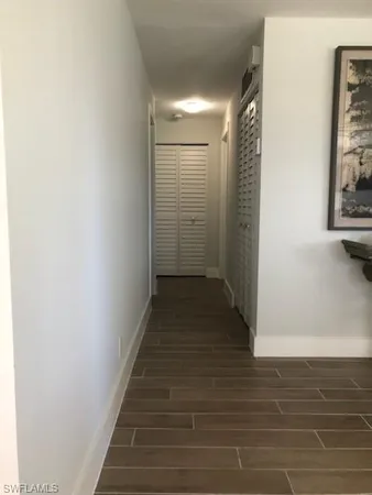 a view of a hallway with wooden floor