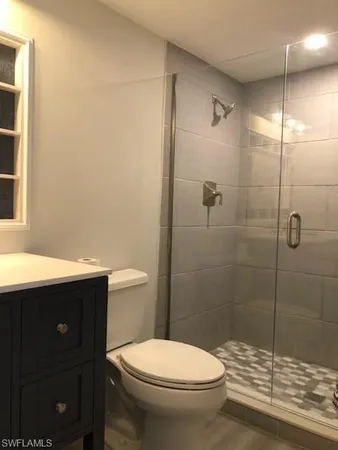 a bathroom with a toilet a sink and shower