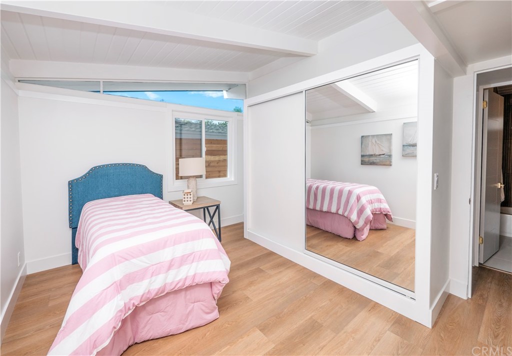 3316 North Studebaker Road Long Beach, CA 90808 - Photo 12 of 29 a bedroom with a bed and a window with wooden floor