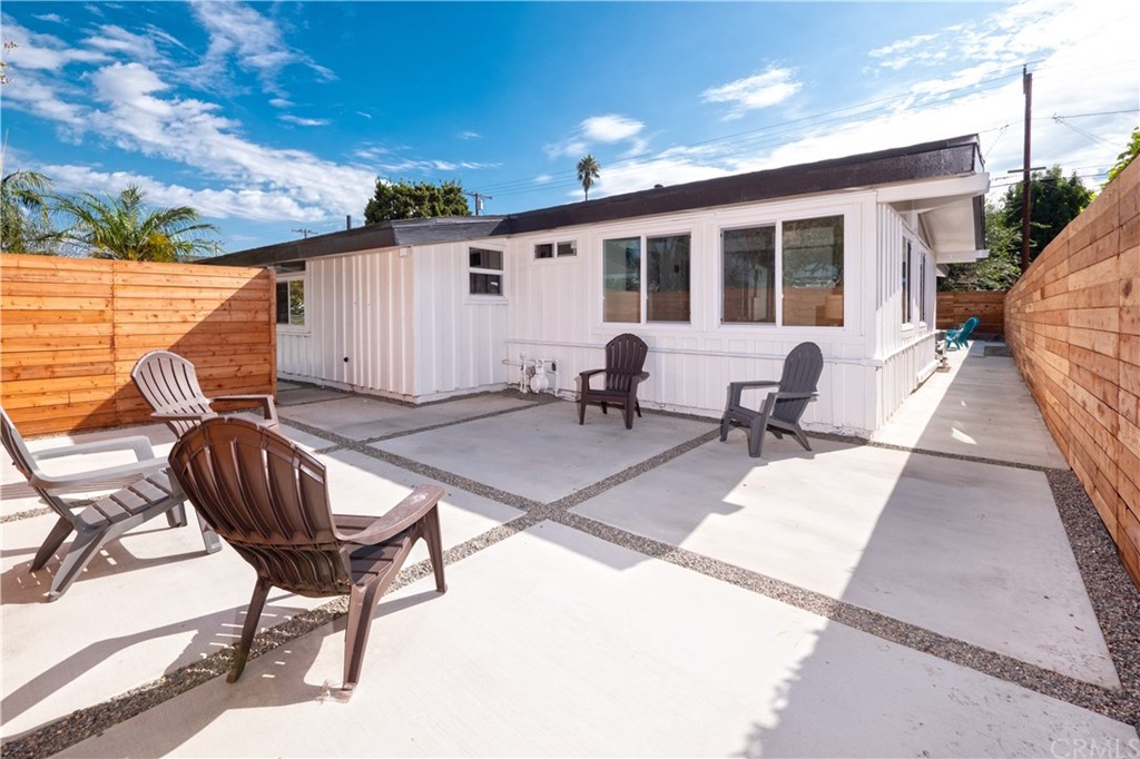 3316 North Studebaker Road Long Beach, CA 90808 - Photo 24 of 29 a view of a patio with table and chairs with wooden floor and fence