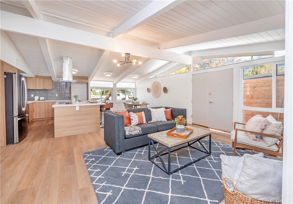 3316 North Studebaker Road Long Beach, CA 90808 - Photo 3 of 29 a living room with furniture and a dining table with kitchen view