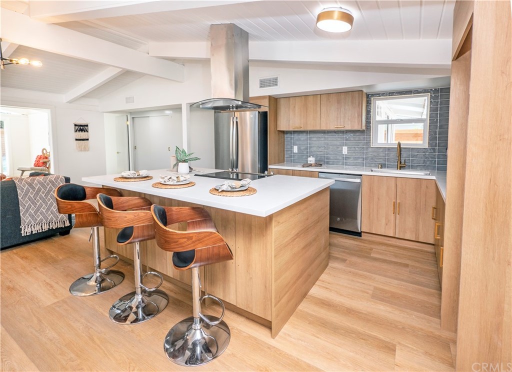 3316 North Studebaker Road Long Beach, CA 90808 - Photo 6 of 29 a large kitchen with a table and chairs in it