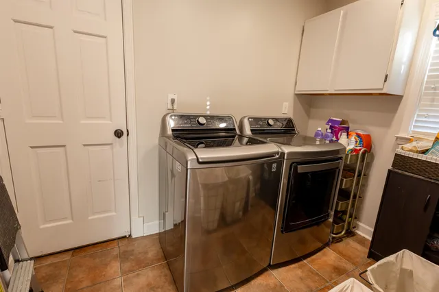 a kitchen with stainless steel appliances white cabinets and white appliances