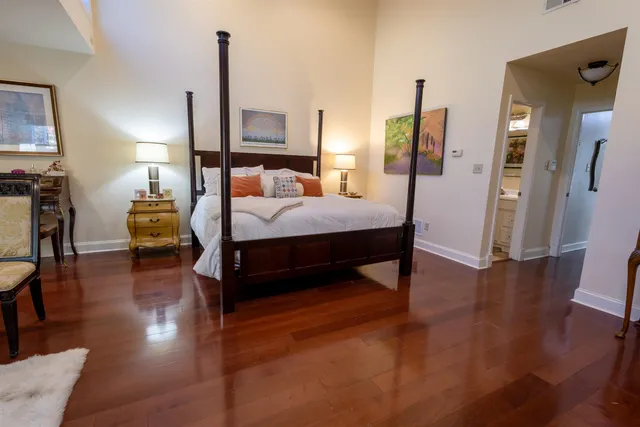 a bedroom with furniture and wooden floor