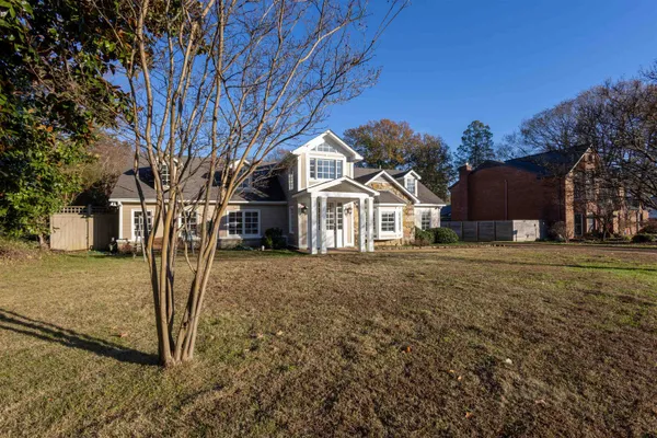 a view of a white house with a yard
