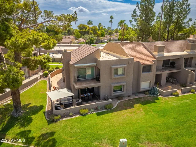 a aerial view of a house with swimming pool garden and patio