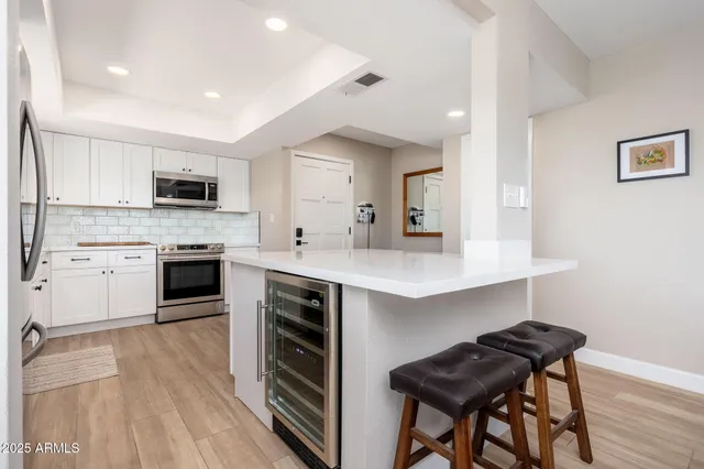 a kitchen with a stove a sink and a refrigerator