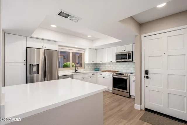 a kitchen with a sink stove and microwave