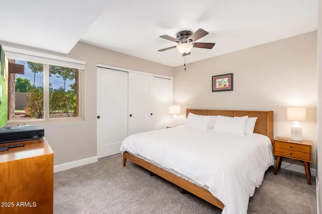 a bathroom with a sink a toilet a mirror and shower