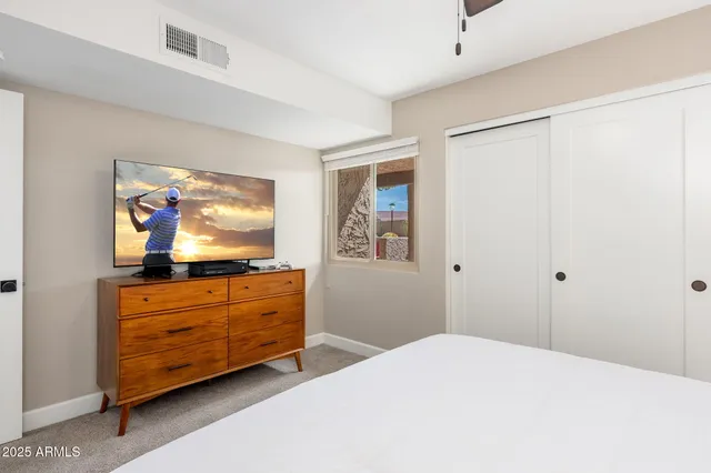 a bedroom with a bed and a chandelier