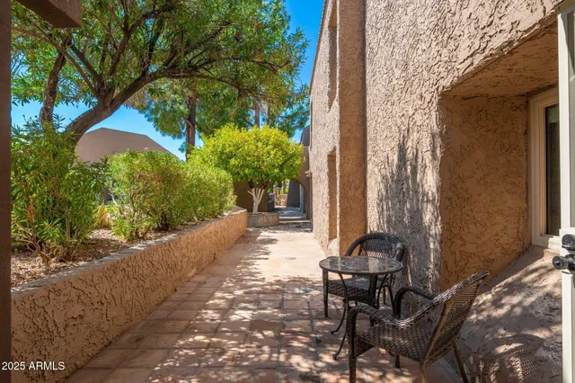 a balcony with table and chairs