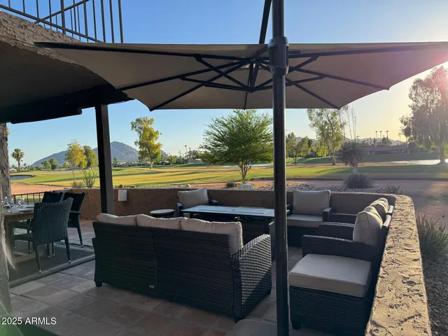 a view of a chair and tables in the patio