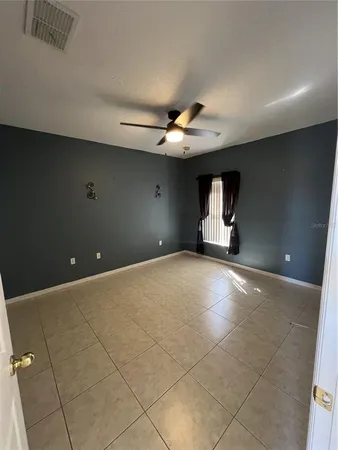 a view of a livingroom with a ceiling fan and window