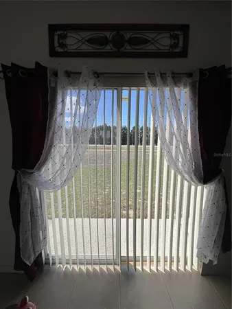 a bedroom with a bed and a ceiling fan