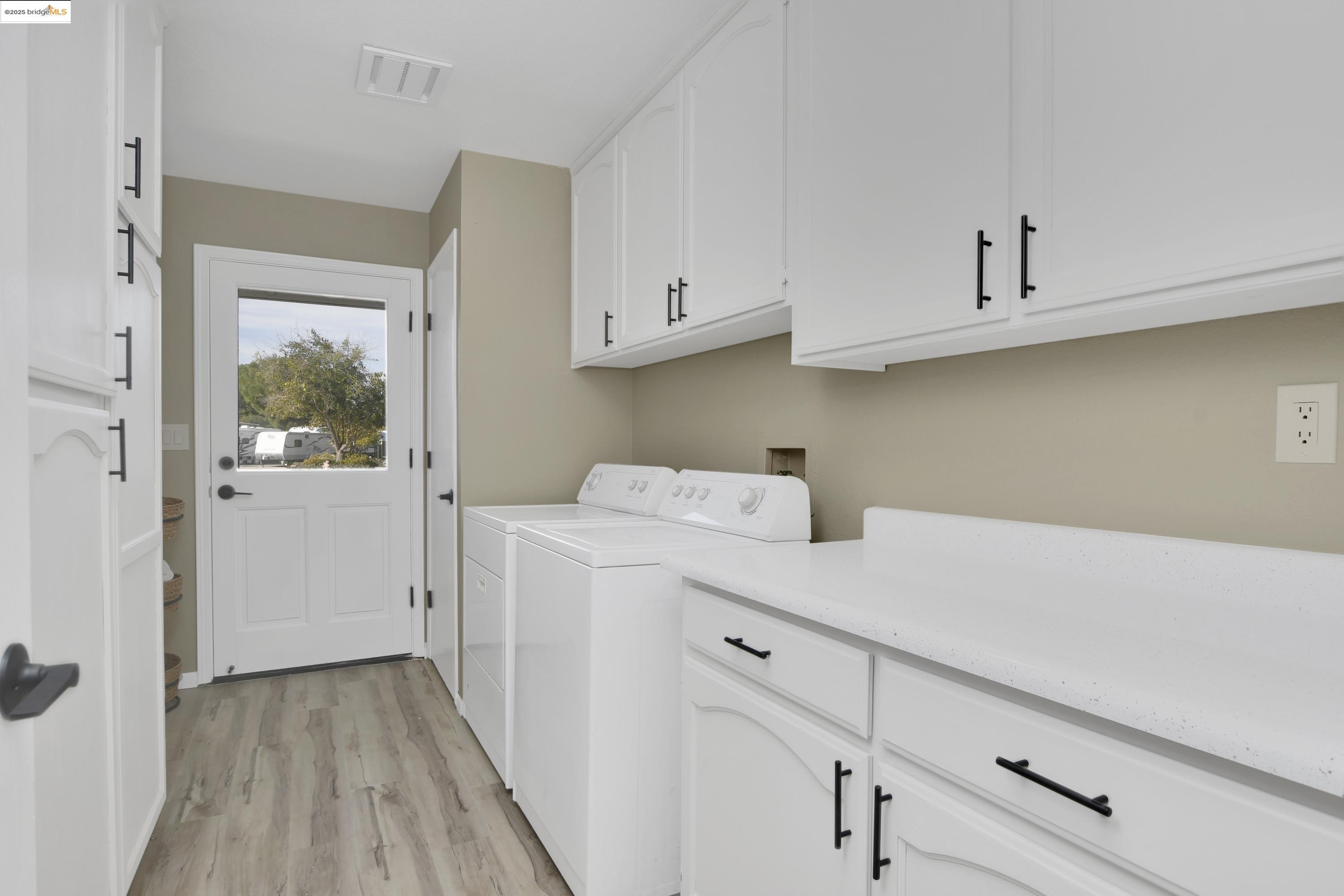 23701 Marsh Creek Road Brentwood, CA 94513 - Photo 14 of 52 a utility room with cabinets washer and dryer