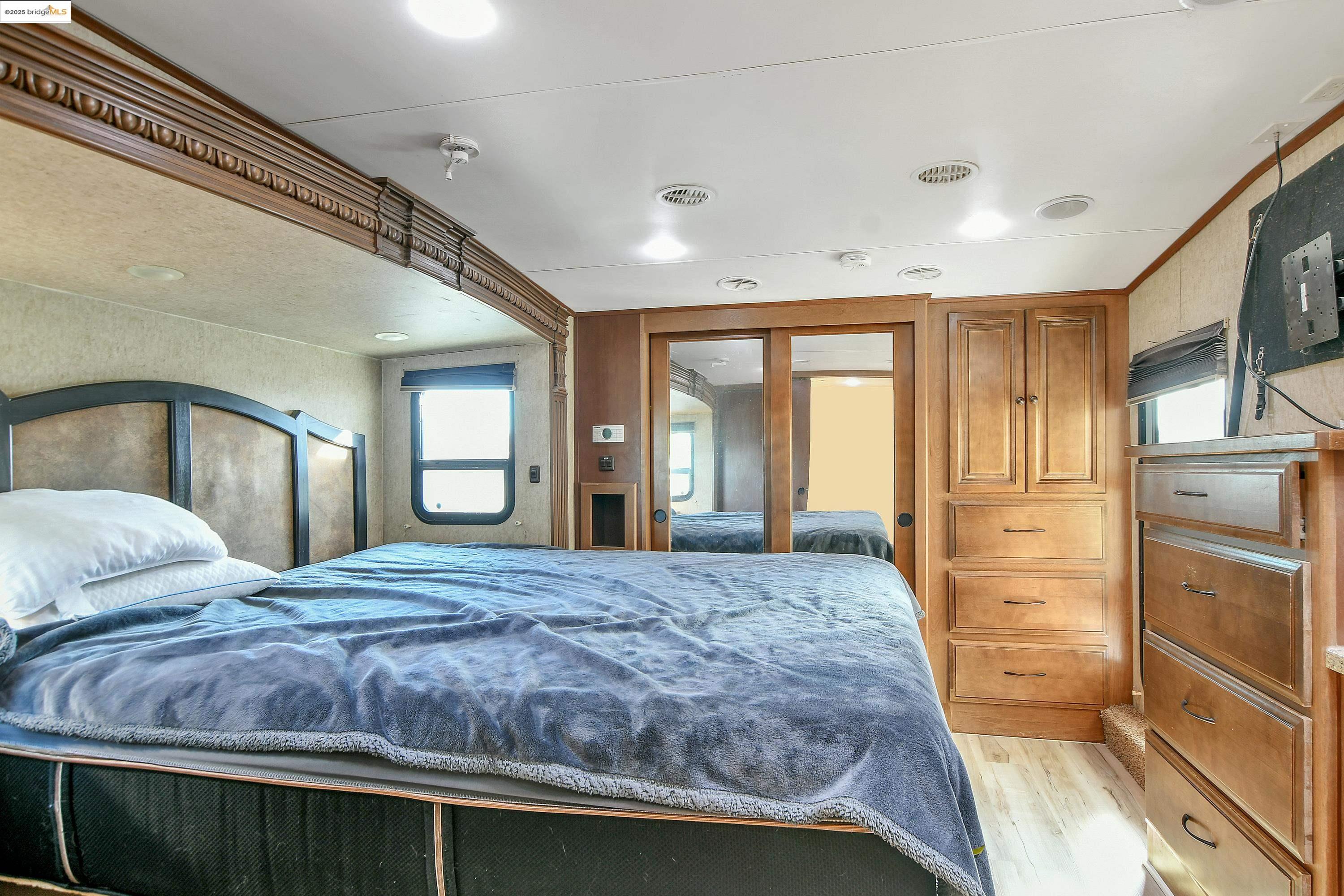 23701 Marsh Creek Road Brentwood, CA 94513 - Photo 30 of 52 a bedroom with a large bed and wooden floor