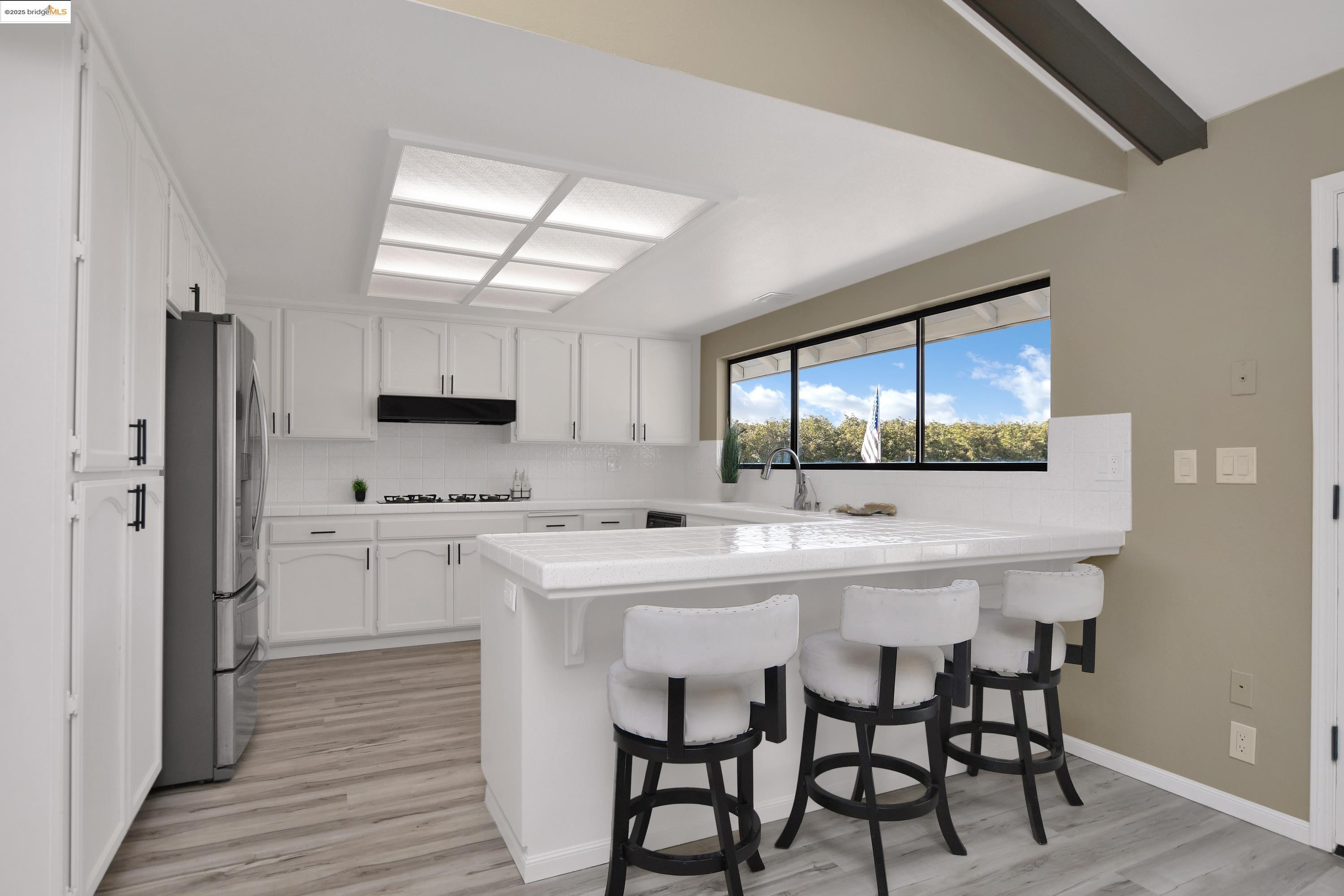23701 Marsh Creek Road Brentwood, CA 94513 - Photo 8 of 52 a kitchen with a table chairs refrigerator and cabinets