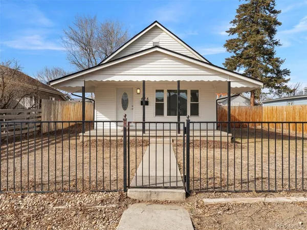 a front view of a house with a iron gate