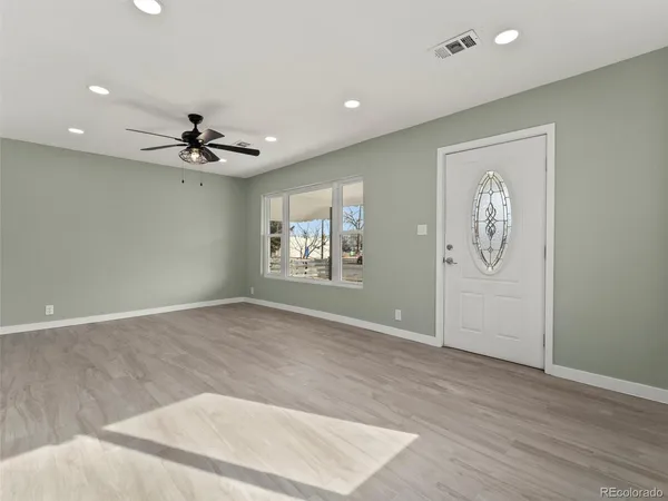 wooden floor in an empty room with a window