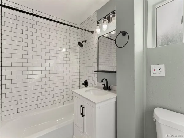 a bathroom with a sink a toilet and a bathtub