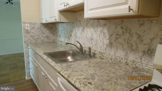 a bathroom with a granite countertop sink a toilet and shower