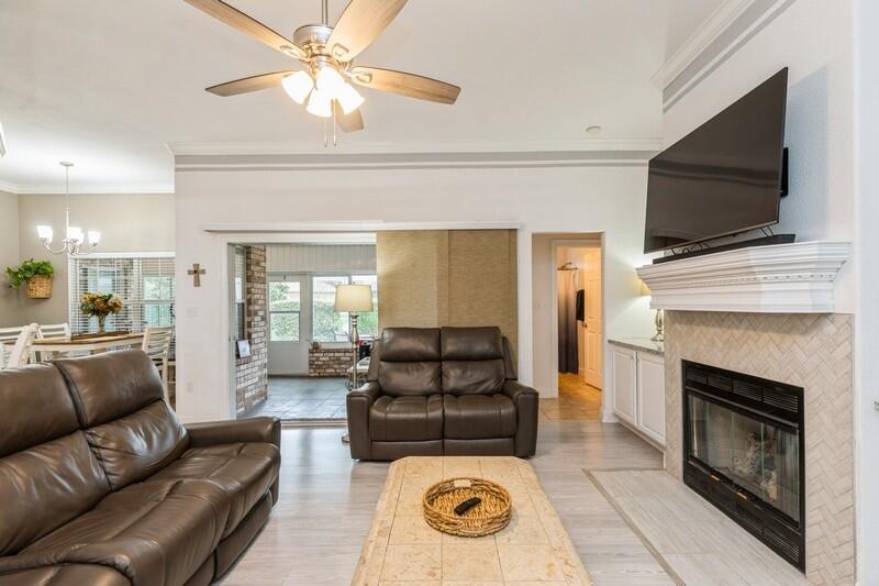 2903 Chancery Lane Crestview, FL 32539 - Photo 14 of 43 a living room with furniture a flat screen tv and a fireplace